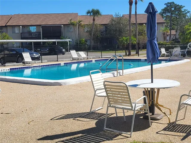 a view of a patio with a dining table and chairs