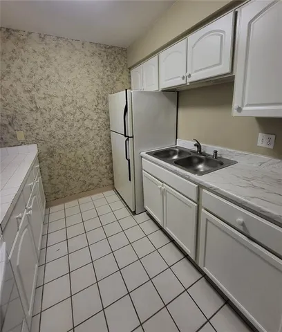 a kitchen with a sink and cabinets