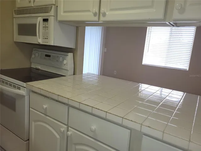 a kitchen with a cabinets and window