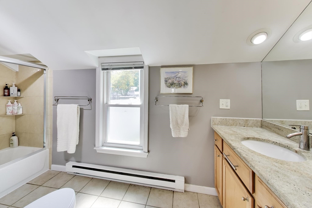 22 Douglas Road Ashland, MA 01721 - Photo 17 of 24 a bathroom with a granite countertop sink a mirror and a bathtub