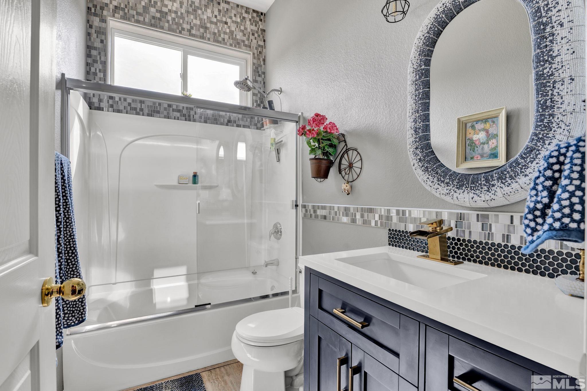 1789 Colavita Way Reno, NV 89521 - Photo 24 of 39 a bathroom with a sink a toilet and a mirror