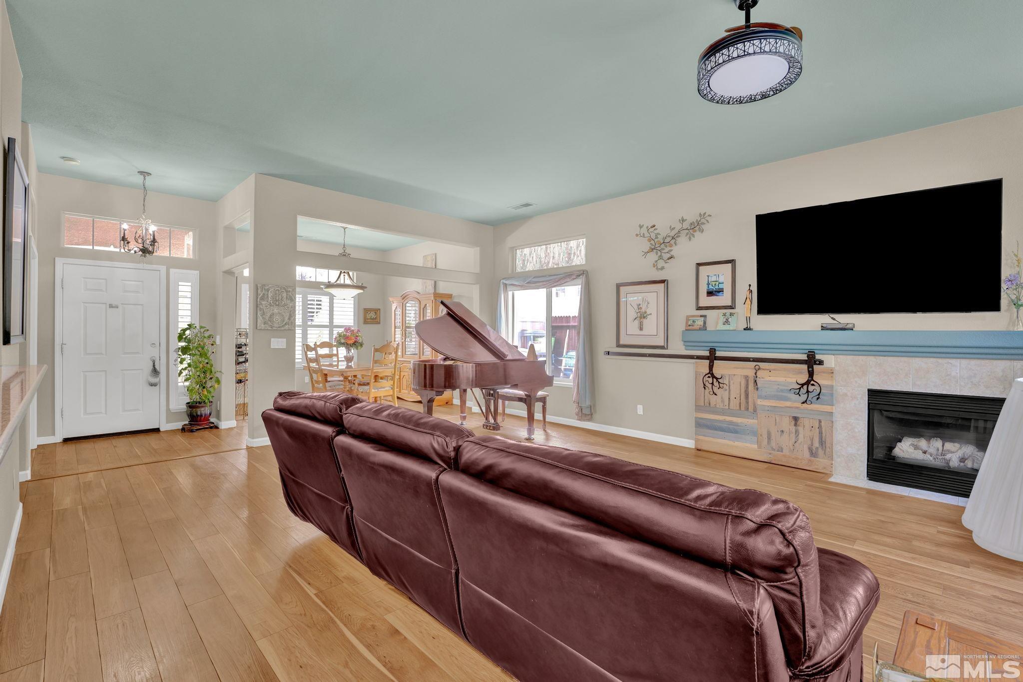 1789 Colavita Way Reno, NV 89521 - Photo 8 of 39 a living room with furniture a flat screen tv and a fireplace