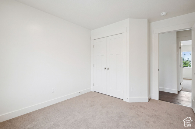 1615 North Angel Street, Unit I Layton, UT 84041 - Photo 22 of 56 Unfurnished bedroom featuring carpet floors and a closet