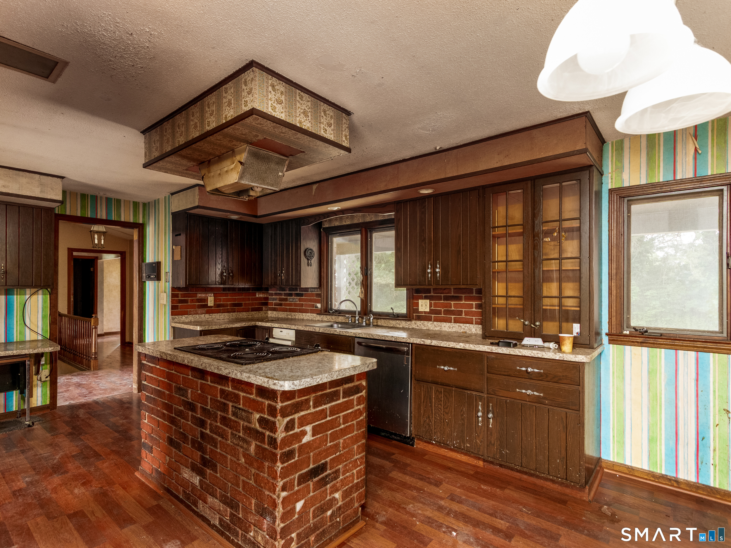 63 High Hill Road Wallingford, CT 06492 - Photo 13 of 34 a kitchen with a stove a sink and a refrigerator