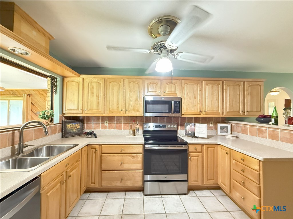 659 County Road 4744 Kempner, TX 76539 - Photo 17 of 48 Stainless steel appliances, to include built-in microwave oven and refrigerator, deep kitchen sinks topped with a gooseneck faucet, and tiled backsplash will delight any cook