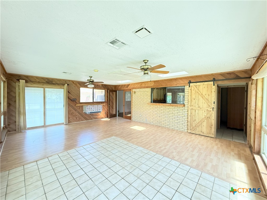 659 County Road 4744 Kempner, TX 76539 - Photo 20 of 48 Sliding glass doors access the covered and open patios while the tile floor insert is the perfect spot for a hot tub