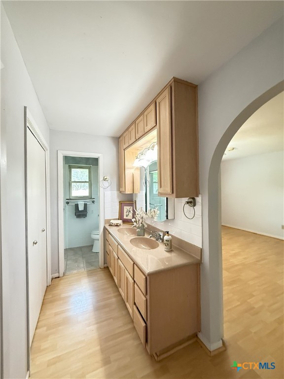 659 County Road 4744 Kempner, TX 76539 - Photo 23 of 48 The barn door enclosed archway links to the primary bathroom, featuring dual sink vanity, twin closets, and separate water closet with oversized, tiled shower compartment