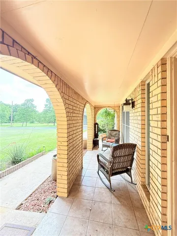 a view of empty room with wooden floor and fireplace