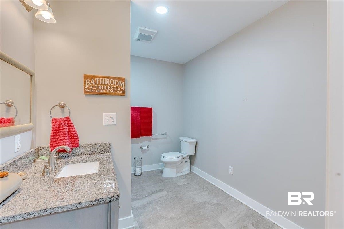 14160 Moffett Road Wilmer, AL 36587 - Photo 31 of 75 Bathroom featuring baseboards, visible vents, toilet, and vanity