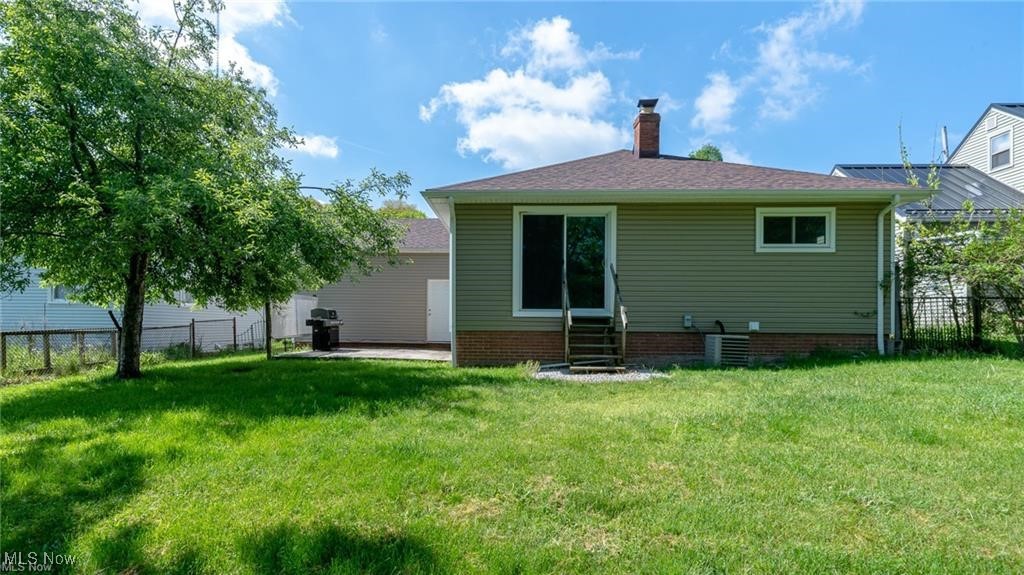 3100 West Ridgewood Drive Cleveland, OH 44134 - Photo 28 of 29 Back view of house with patio and chain linked fence