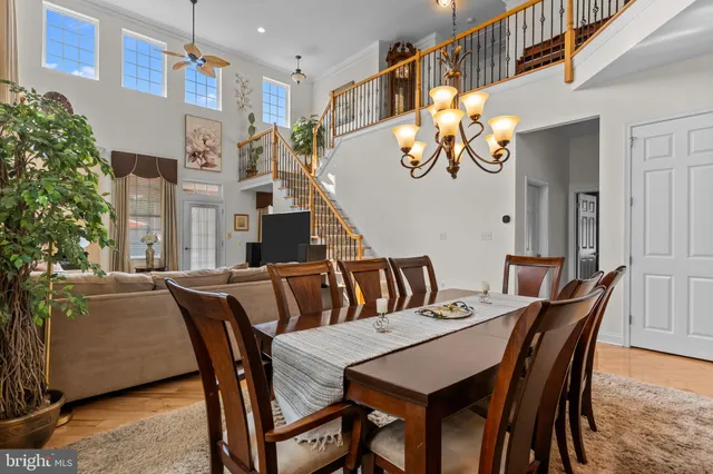 a view of a dining room with furniture and a potted plant
