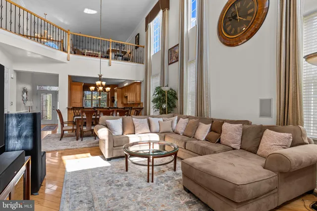a living room with furniture a flat screen tv and a table