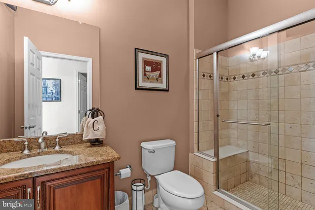 a spacious bedroom with a large bed and a chandelier