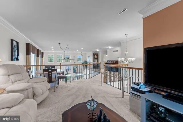 a living room with a bed furniture and a flat screen tv