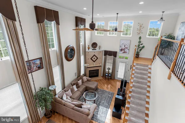 a view of a patio with a dining table chairs and a floor to ceiling window