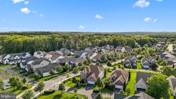 an aerial view of multiple houses with yard