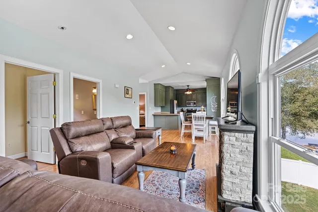 a living room with furniture fireplace and a large window