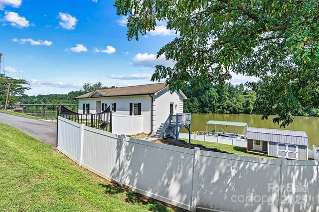 a view of a house with a backyard and sitting area