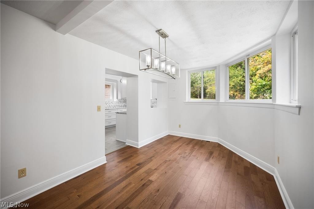 28300 Aurora Road Solon, OH 44139 - Photo 12 of 36 Bright room featuring wood-finish flooring, white trim, and multiple windows