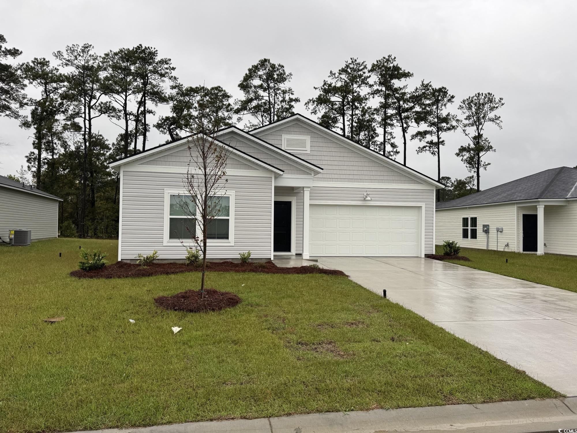867 Long Bch Loop Longs, SC 29568 - Photo 1 of 26 Ranch-style home featuring concrete driveway, a front yard, and a garage