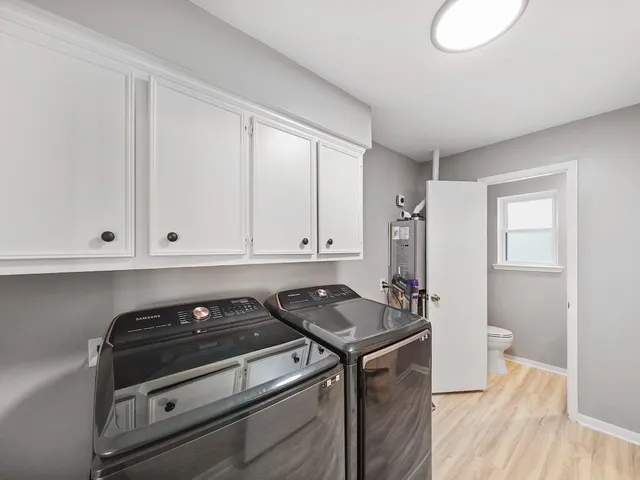 a kitchen with a stove and white cabinets