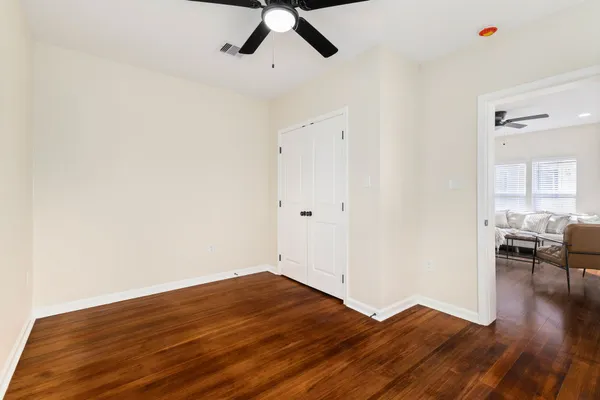 a view of empty room with wooden floor
