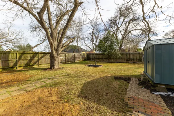 a view of yard covered with snow in front of house