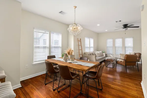 a view of a a dining room with furniture window and wooden floor