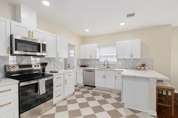 a kitchen with a sink stove and microwave