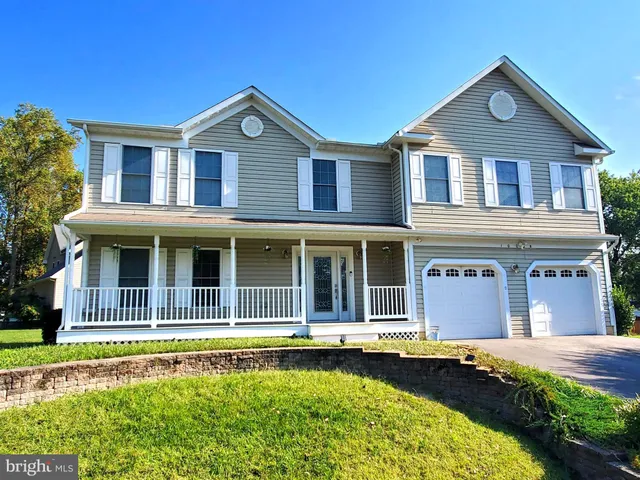 a front view of a house with swimming pool and porch