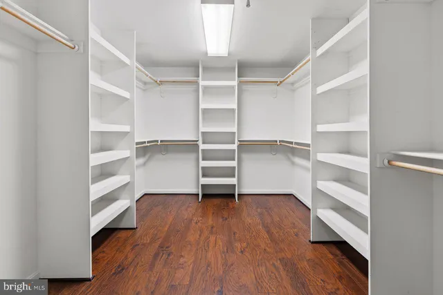 a view of walk in closet with empty racks