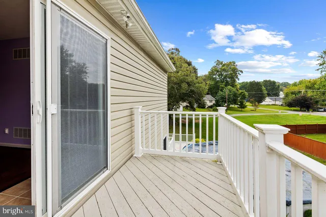 a balcony with wooden floor and fence