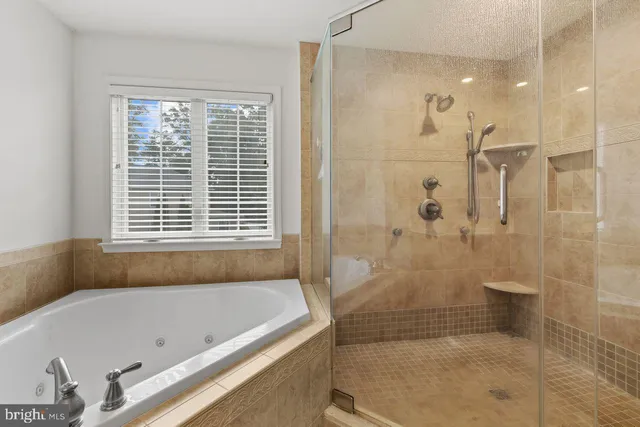 a bathroom with a bathtub and shower