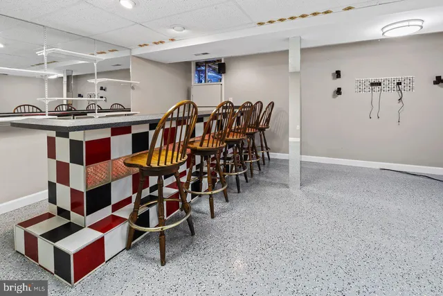 a living room with furniture and a clock