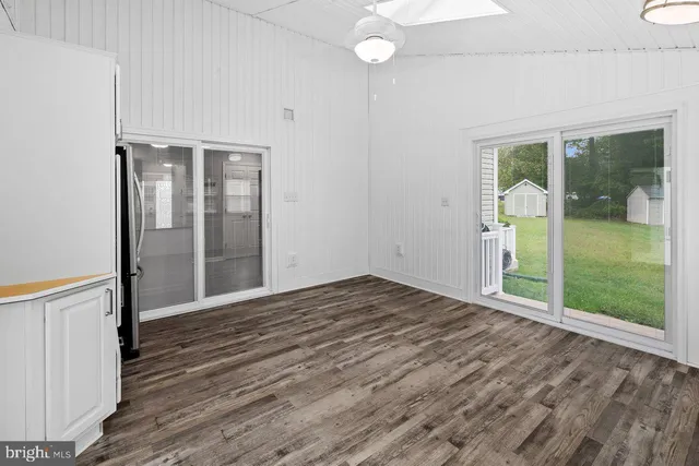 a view of an empty room with glass door