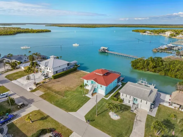 an aerial view of a house with a ocean view