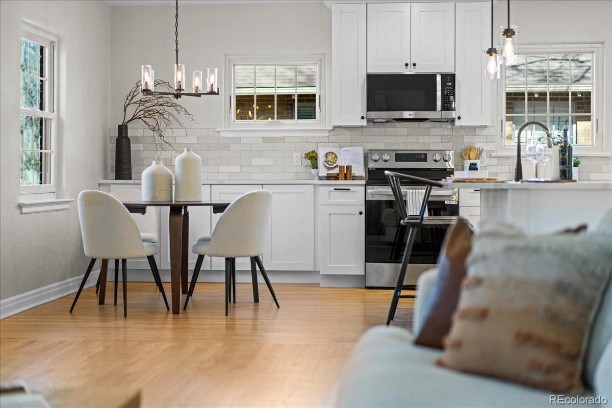 1378 Forest Street Denver, CO 80220 - Photo 12 of 50 a dining area with furniture a flat screen tv and kitchen view