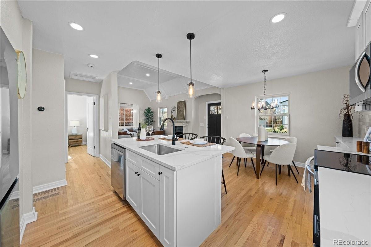 1378 Forest Street Denver, CO 80220 - Photo 14 of 50 a view of a dining room and livingroom with furniture wooden floor a chandelier