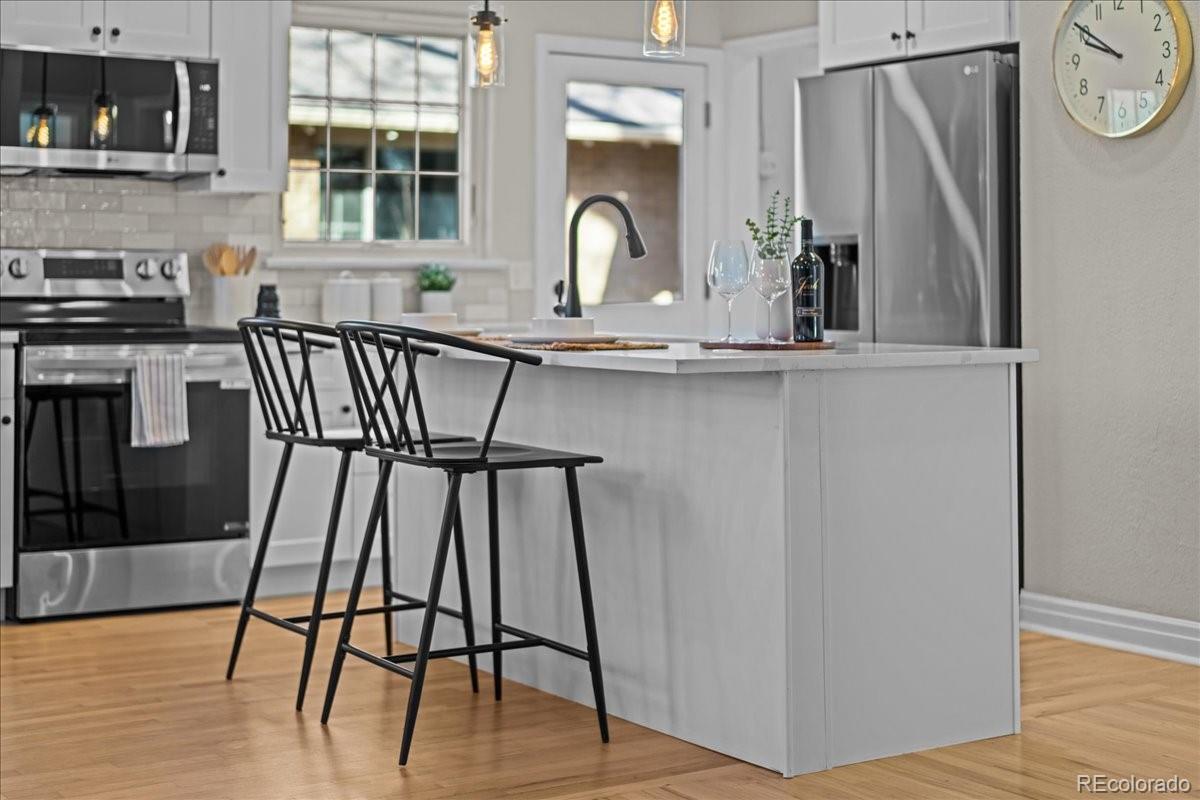 1378 Forest Street Denver, CO 80220 - Photo 16 of 50 a view of a dining room with furniture and wooden floor