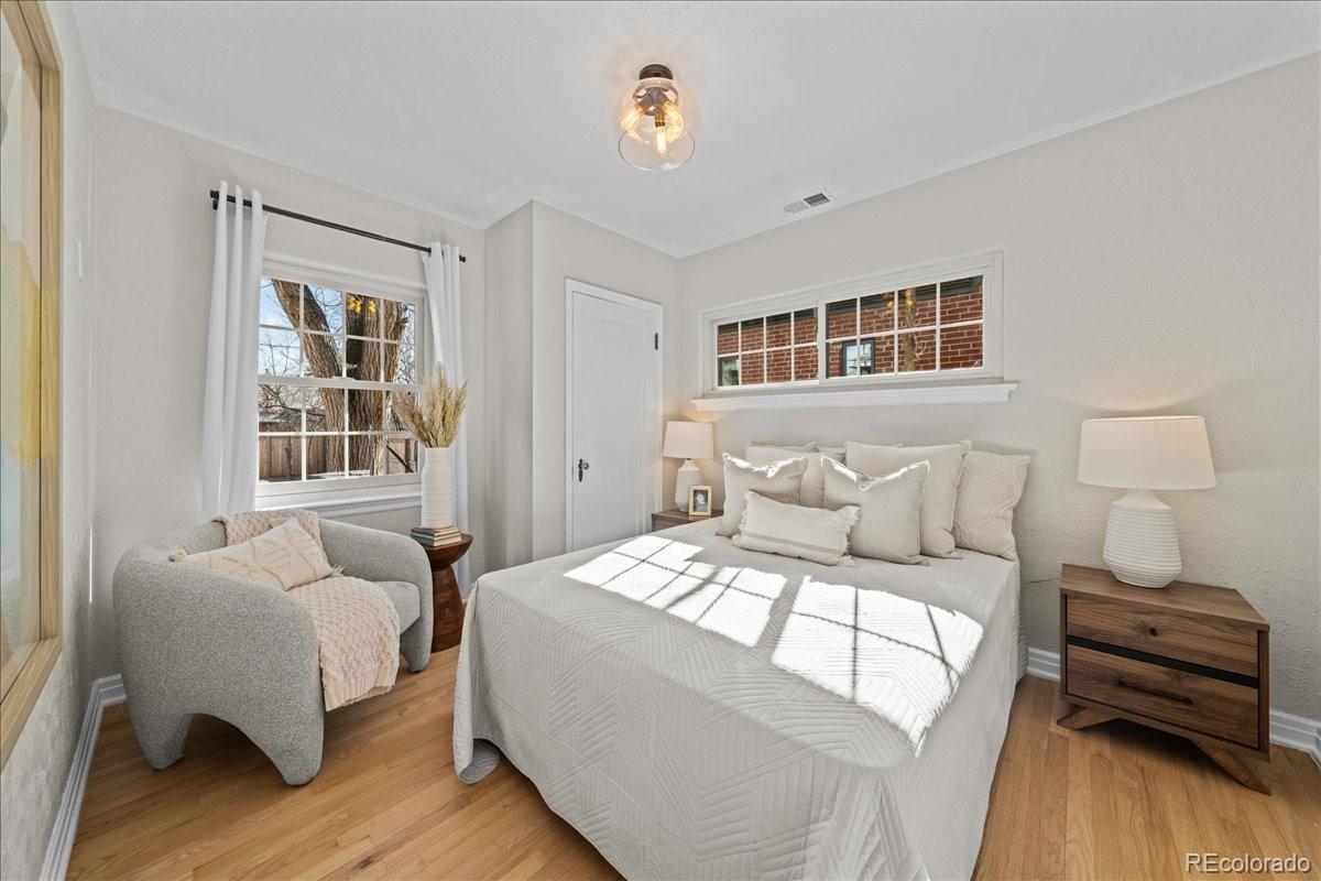 1378 Forest Street Denver, CO 80220 - Photo 18 of 50 a bedroom with a bed and wooden floor