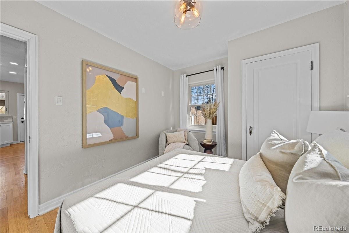 1378 Forest Street Denver, CO 80220 - Photo 19 of 50 a bedroom with a bed and wooden floor