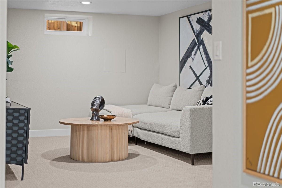 1378 Forest Street Denver, CO 80220 - Photo 27 of 50 a living room with furniture a flat screen tv and a window