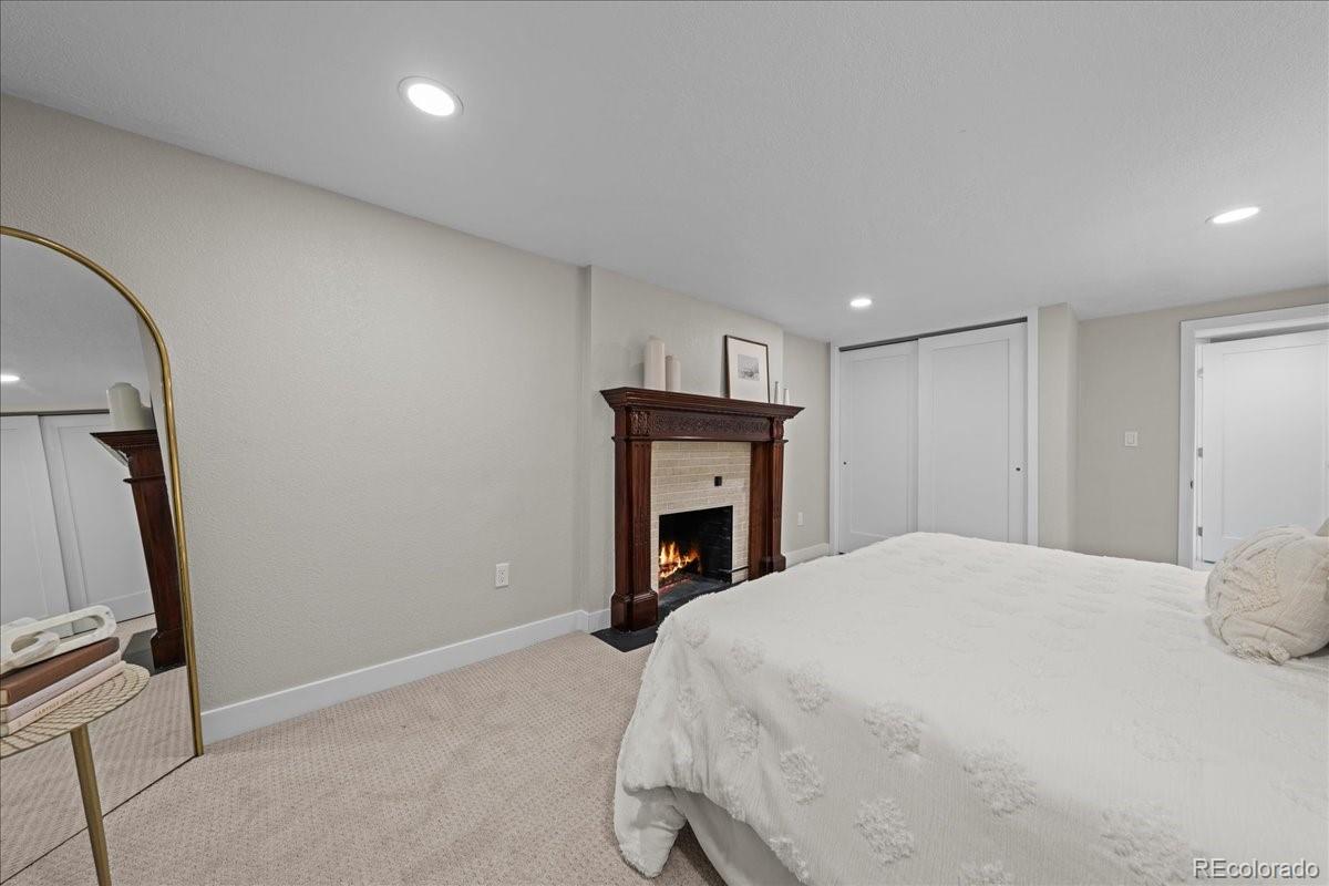 1378 Forest Street Denver, CO 80220 - Photo 34 of 50 a bedroom with a bed and a fireplace