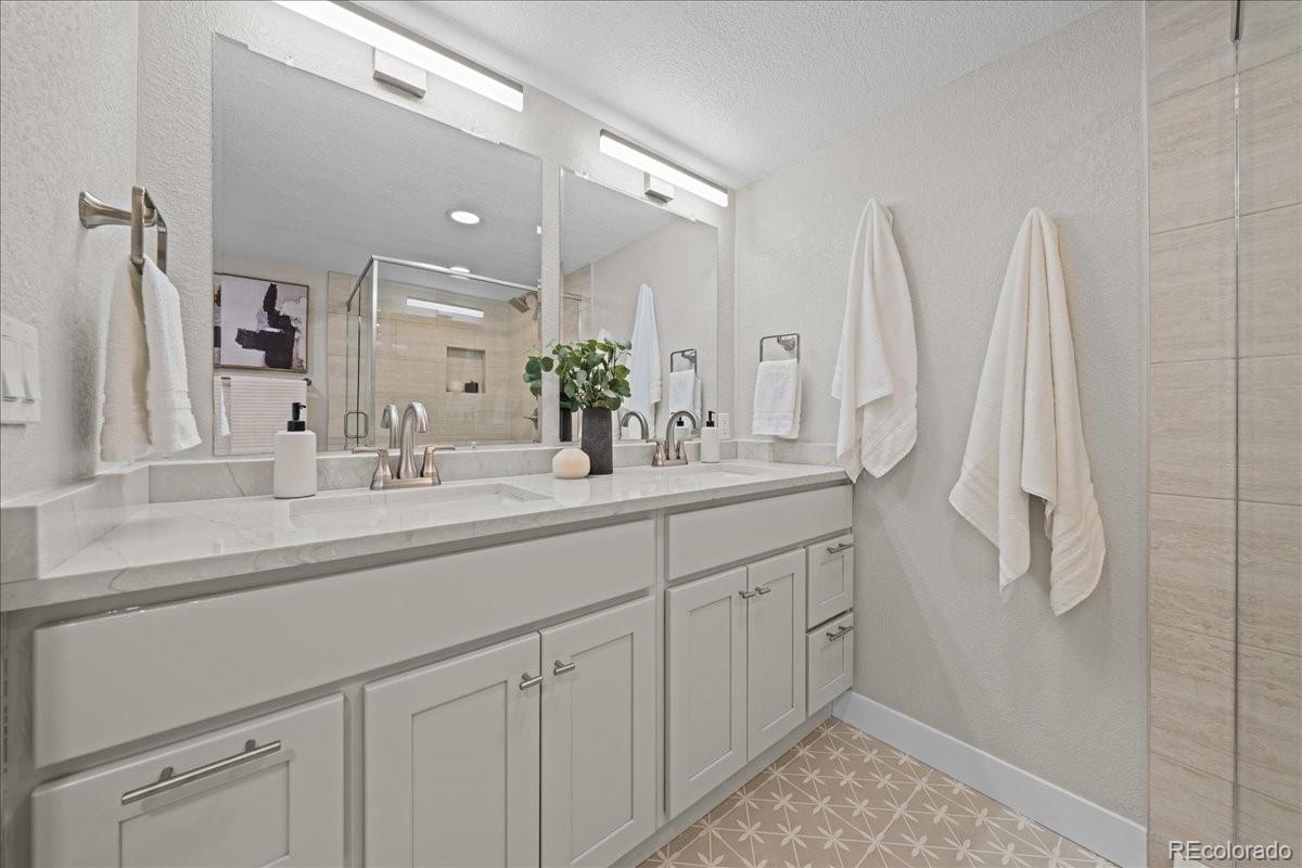 1378 Forest Street Denver, CO 80220 - Photo 35 of 50 a bathroom with a double vanity sink and a mirror