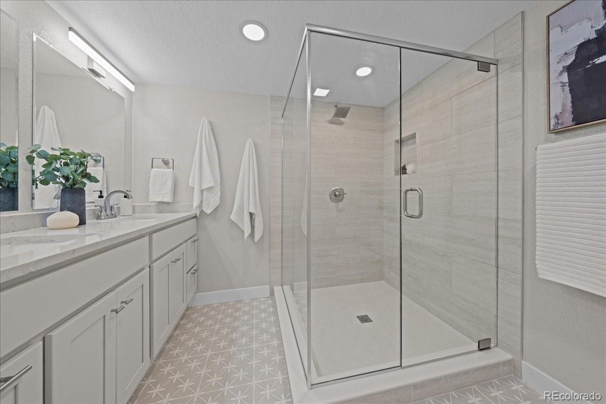 1378 Forest Street Denver, CO 80220 - Photo 36 of 50 a bathroom with a shower sink and mirror