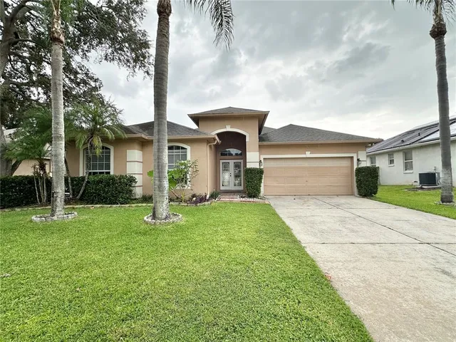 a front view of a house with a yard and garage