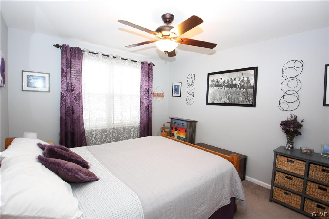3838 Rittenhouse Road Lower Macungie Township, PA 18062 - Photo 16 of 26 a bedroom with a large bed and a chandelier
