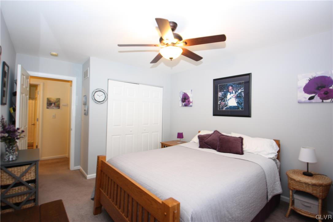 3838 Rittenhouse Road Lower Macungie Township, PA 18062 - Photo 17 of 26 a bedroom with a bed and a chandelier