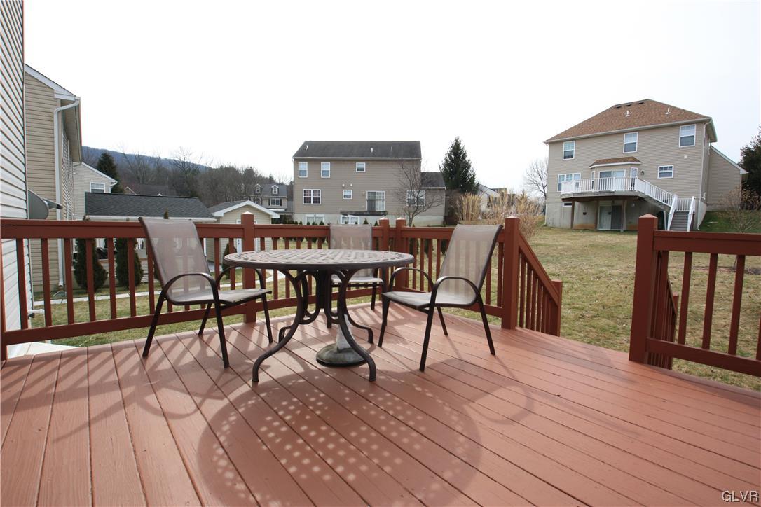 3838 Rittenhouse Road Lower Macungie Township, PA 18062 - Photo 24 of 26 a view of a roof deck with table and chairs a barbeque with wooden floor and fence