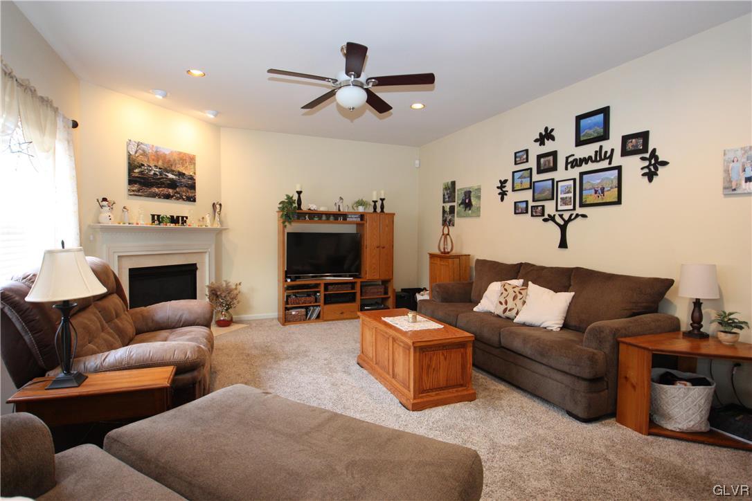 3838 Rittenhouse Road Lower Macungie Township, PA 18062 - Photo 5 of 26 a living room with furniture a fireplace and a flat screen tv